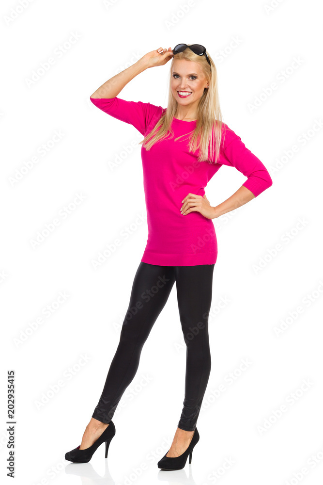 Beautiful Woman Is Standing, Looking At Camera And Smiling Beautiful Woman Is Standing, Looking At Camera And Smiling