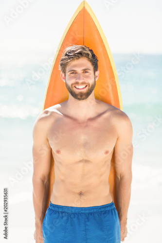 Handsome man holding surfboard 