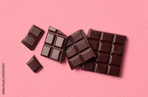 Dark chocolate on pink background
