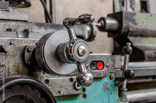 Adjustment knob on a vintage lathe in the workshop of a locksmith