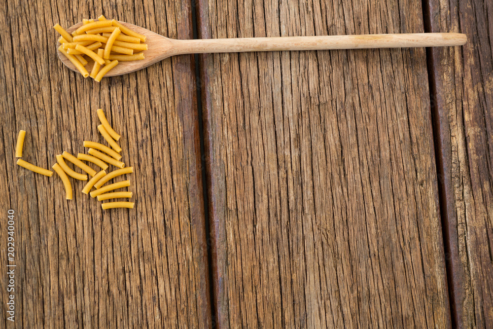 Macaroni pasta on wooden surface Macaroni pasta on wooden surface