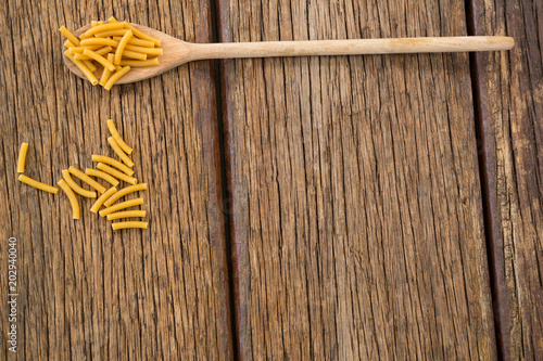 Macaroni pasta on wooden surface