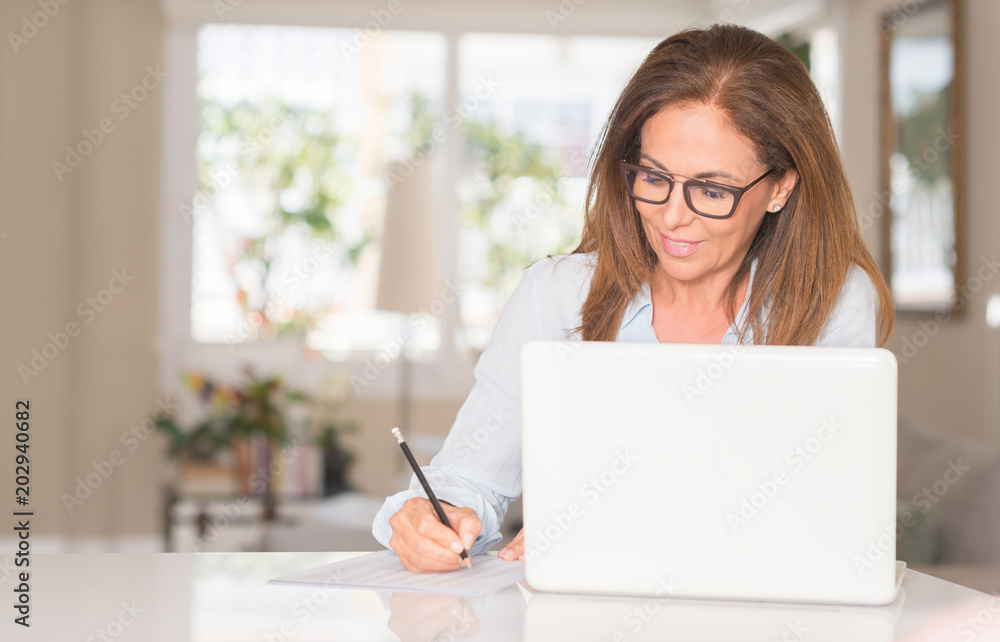 Middle age woman using laptop computer, indoor Middle age woman using laptop computer, indoor