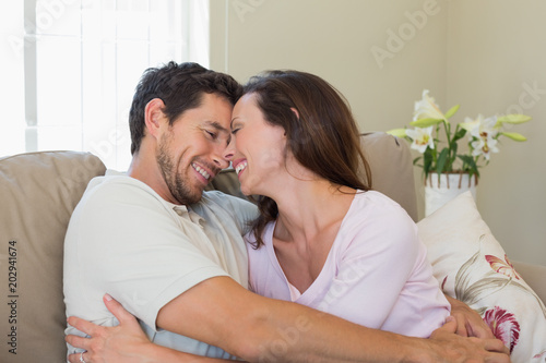 Cheerful loving couple on couch at home © WavebreakmediaMicro