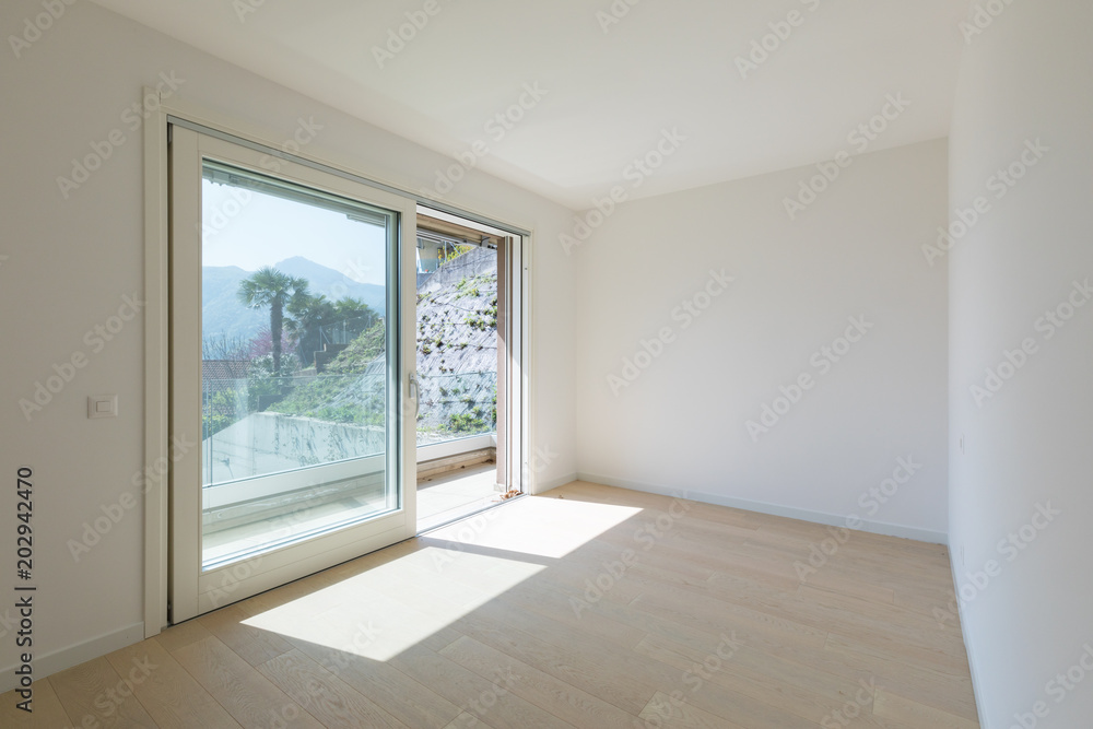 Empty white room with large window with a view. Empty white room with large window with a view.