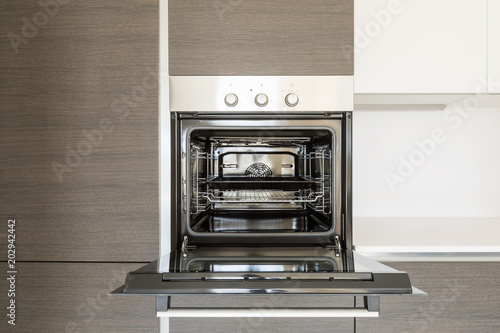 Detail of open kitchen oven photo