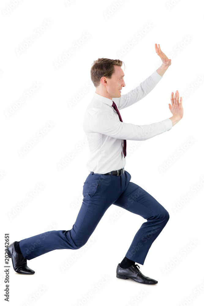A businessman pushing something A businessman pushing something