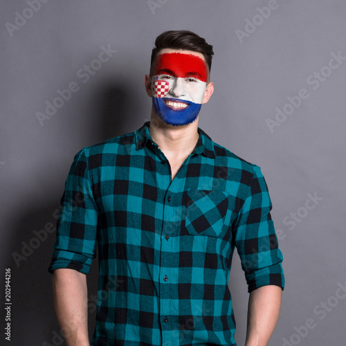 Young man with Croatia flag painted on his face