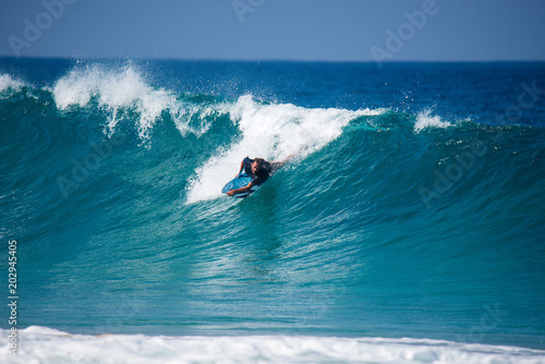 A surfer who surfers a big wave