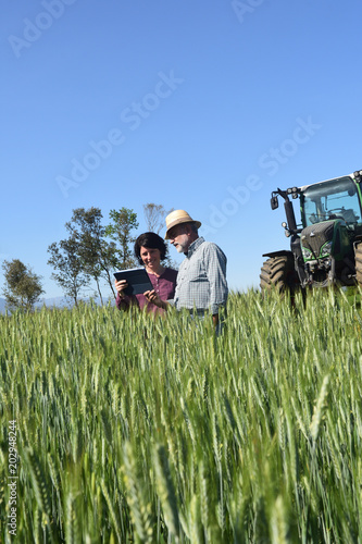 couple of farmers looking at a field