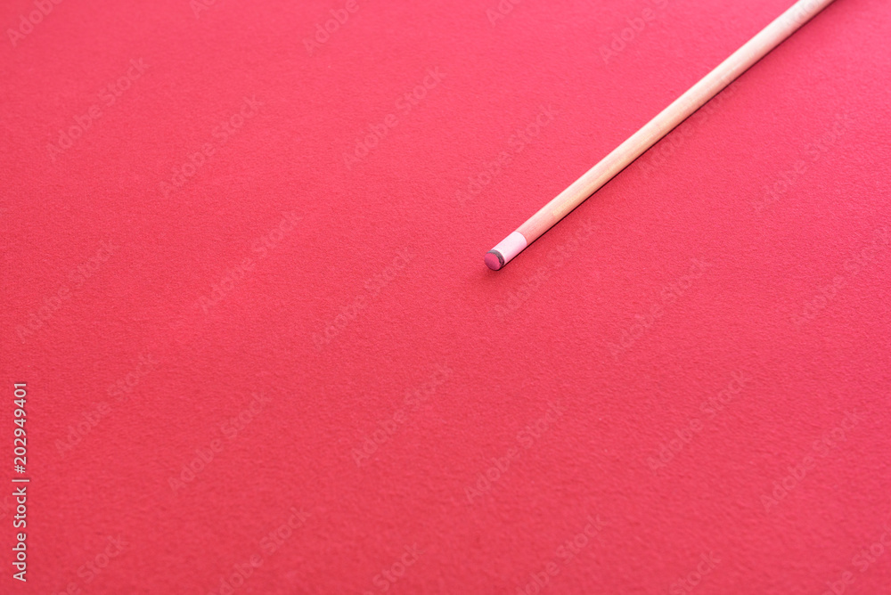 Wooden Cue Stick , snooker or pool cue on Red flannel or velvet on billiard table Wooden Cue Stick , snooker or pool cue on Red flannel or velvet on billiard table
