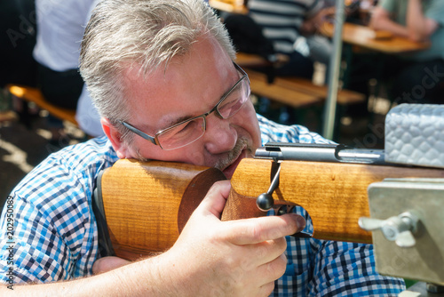 Wallpaper Mural White man with glasses shoots with gun at the shooting gallery Torontodigital.ca