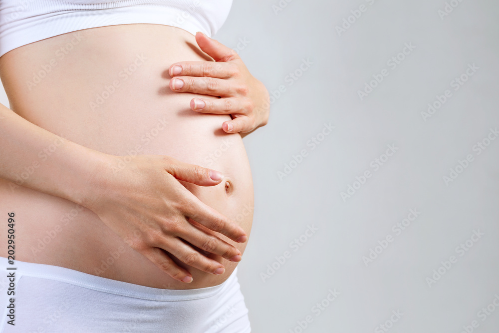 Ταπετσαρία Young pregnant woman caress belly.