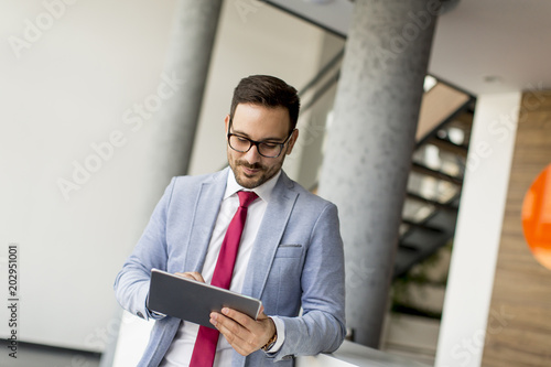 Young businessman with digital tablet in office