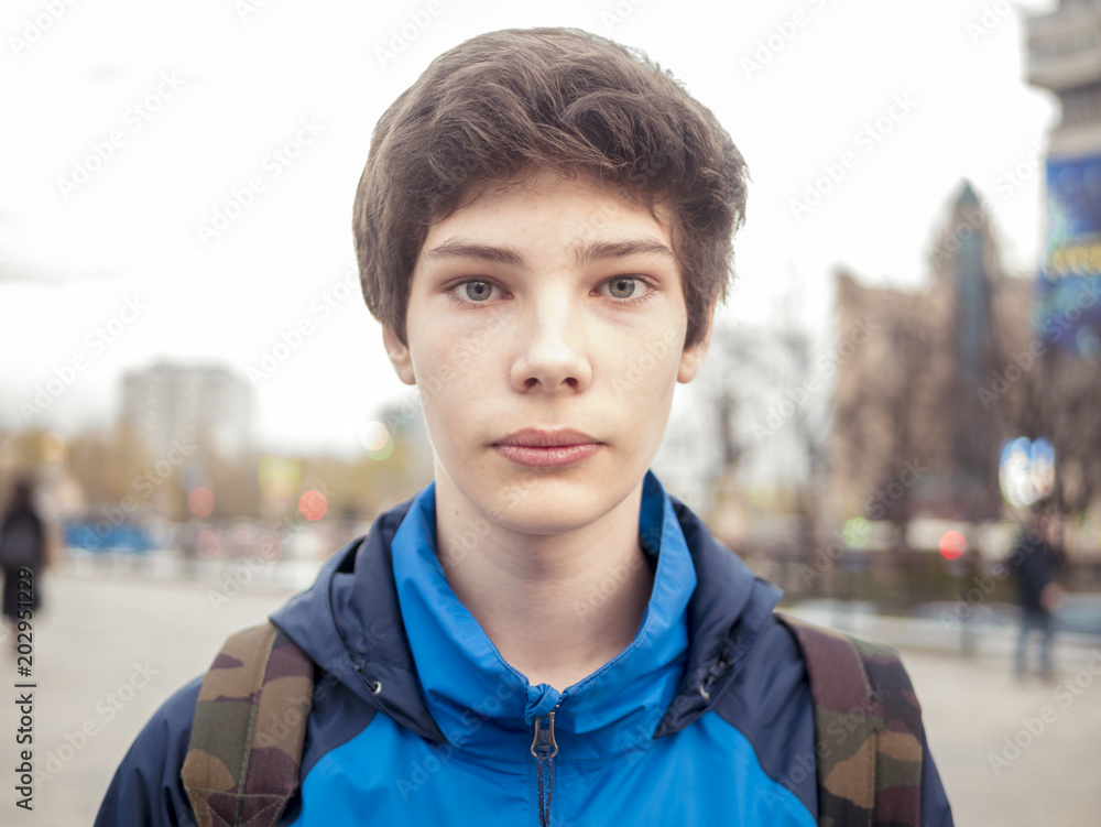 close up portraing of a young boy 14-16 years in the city close up portraing of a young boy 14-16 years in the city
