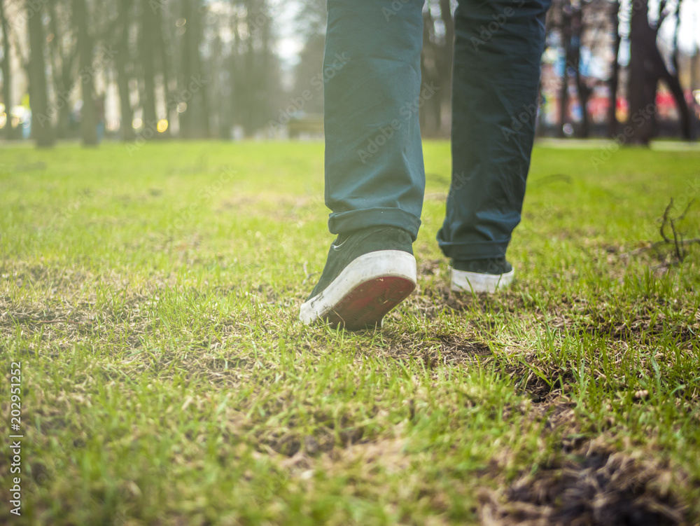 close up foot steps on the grass