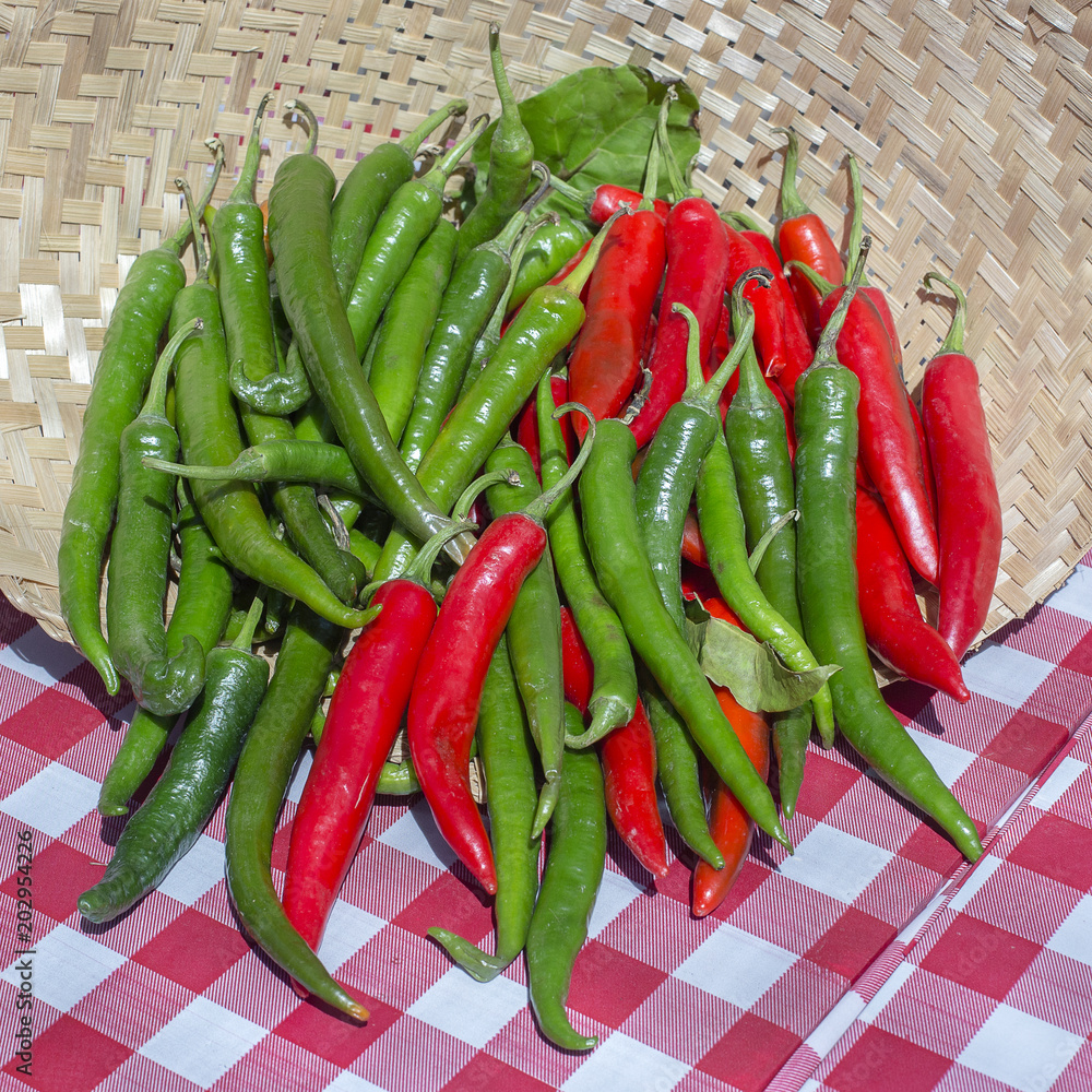 Organic, fresh, raw green and red peppers for sale at a local farmers market in Bali, Indonesia. Close up