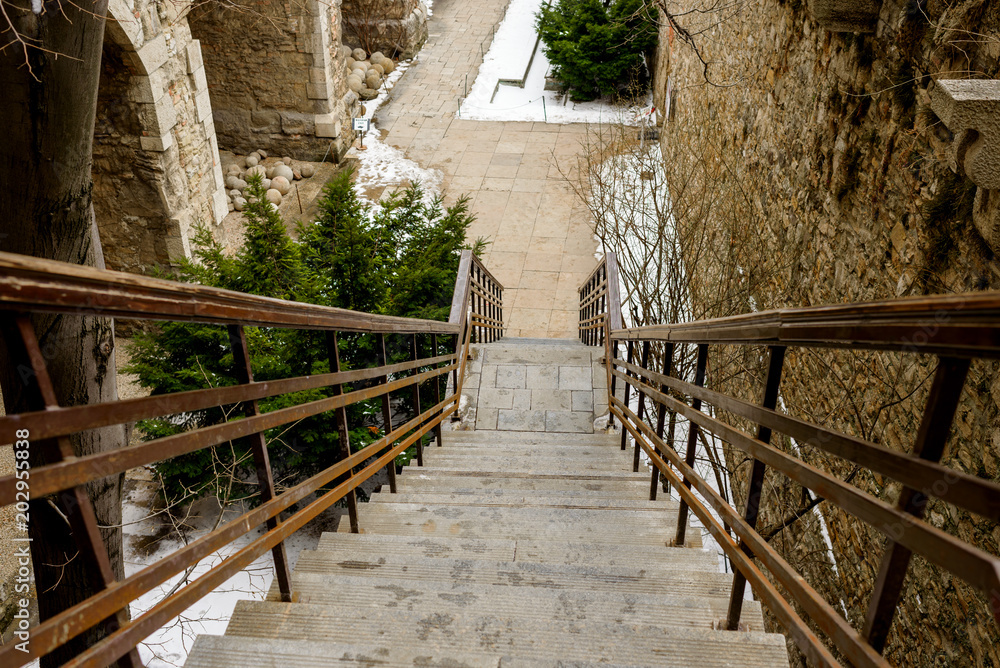 Obraz premium stone steps in the courtyard in winter, top view
