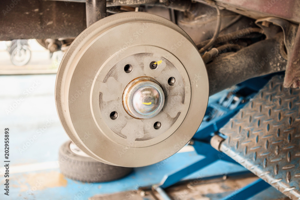 tyre replacement service, Car brake without wheels at auto repair shop