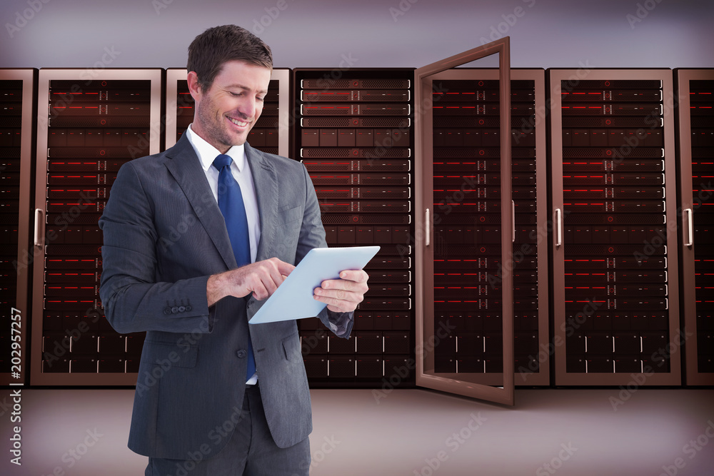 Fotografie Businessman using his tablet pc  against server towers