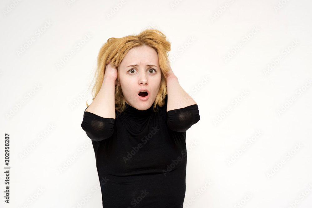 Portrait of a beautiful blonde girl on a white background showing surprise and delight. Portrait of a beautiful blonde girl on a white background showing surprise and delight.