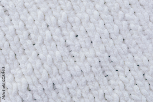 White knitted needles texture, pigtails. English gum. Background.