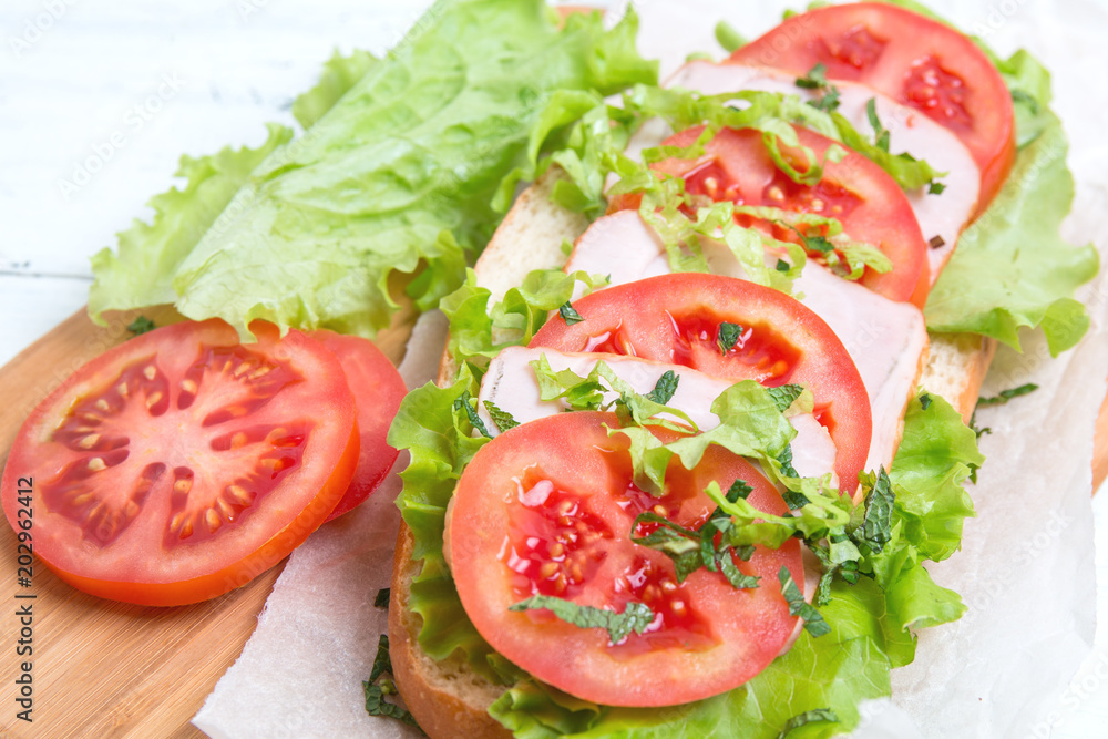baguette sandwich with ham,tomatoes and lettuce