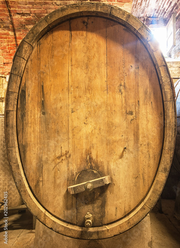 Old wooden barrels with wine in a wine vault