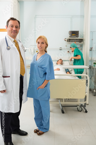 Doctor and nurse standing in a hospital room