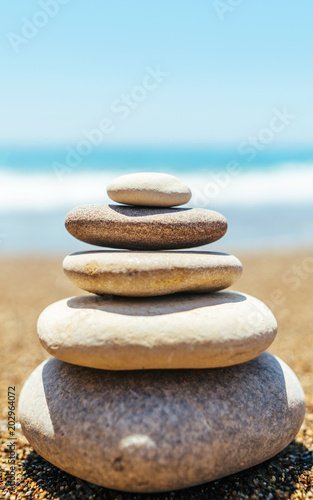 Stack of zen stones on the beach near sea