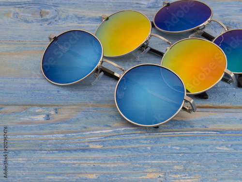 sunglasses on a blue wooden background. 