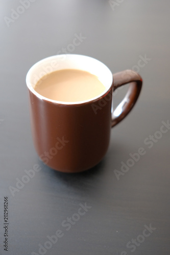 shot of cup of coffee on table against black background