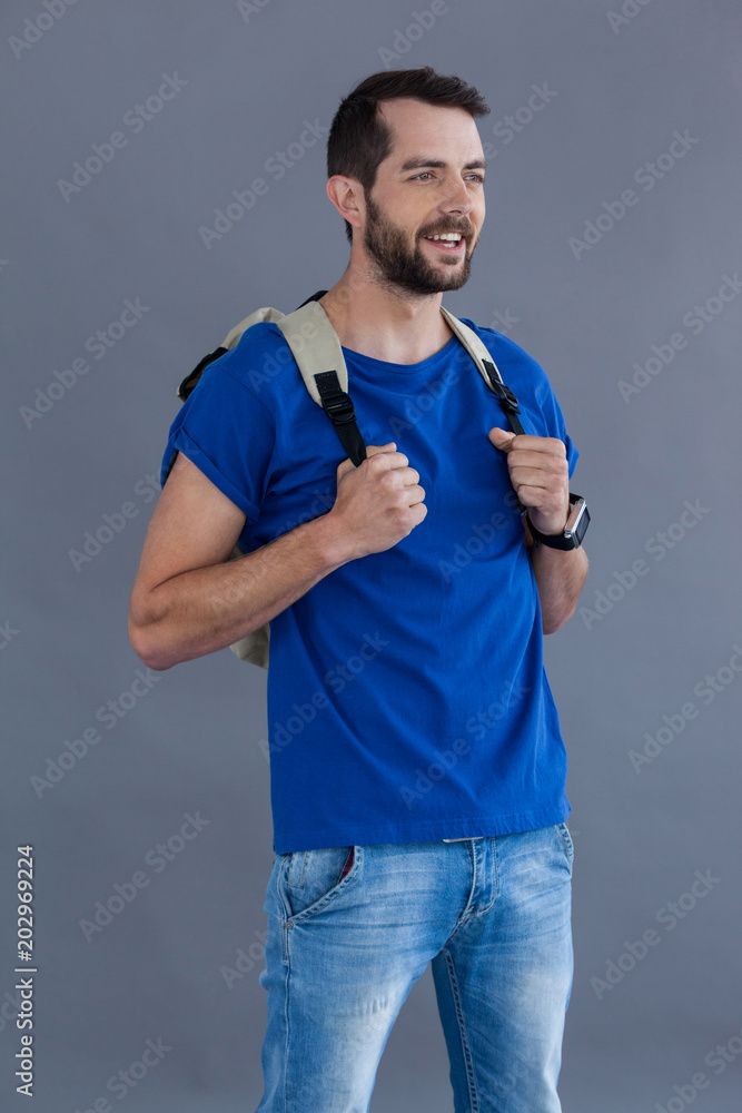 Happy man in blue t-shirt with backpack