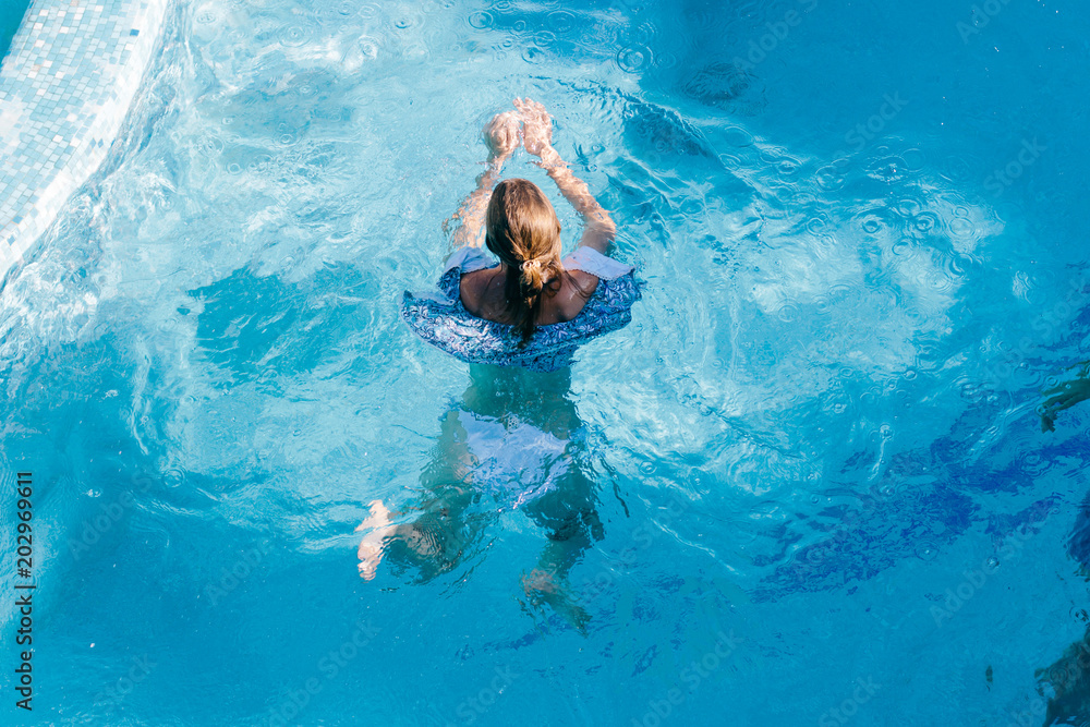  the girl is swimming in the pool