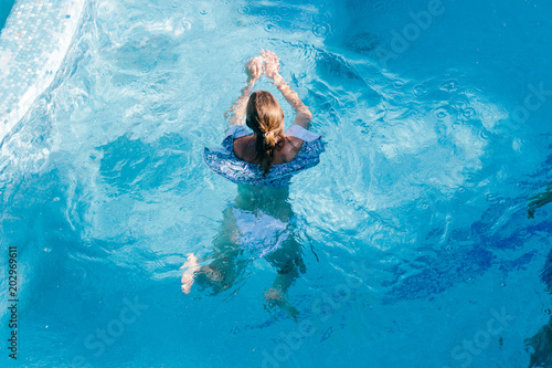  the girl is swimming in the pool
