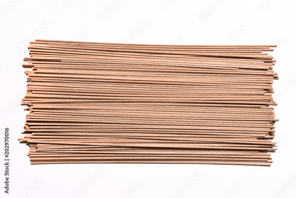 Beautiful buckwheat noodles, raw, not cooked, on white background Beautiful buckwheat noodles, raw, not cooked, on white background