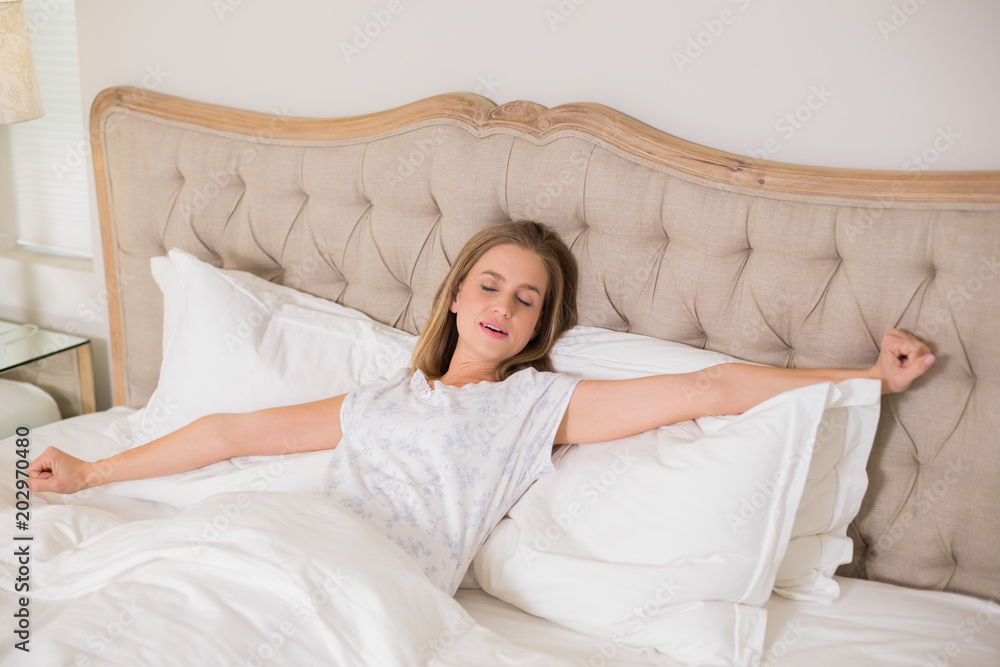 Natural frowning woman yawning and resting in bed Natural frowning woman yawning and resting in bed