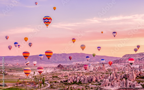 Colorful hot air balloons flying over rock landscape at Cappadocia Turkey photo