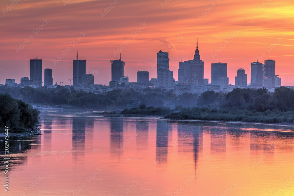 Evening panorama of Warsaw skyline over Vistula river at sunset, Poland