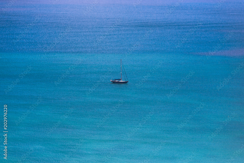Sailing boat in a beautiful turquoise sea in the calm waters of the Mediterranean Sailing boat in a beautiful turquoise sea in the calm waters of the Mediterranean