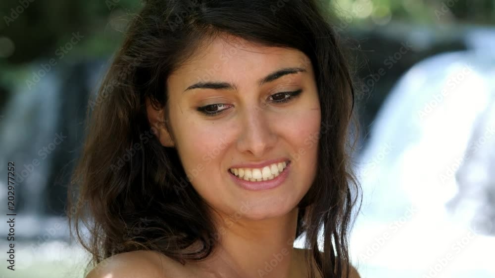 Beautiful young woman turning his head and smiles Beautiful young woman turning his head and smiles