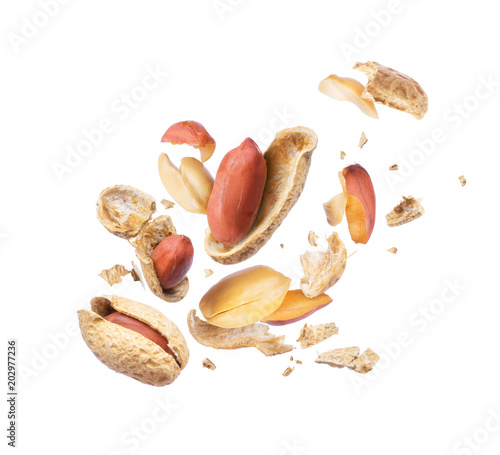 Dried peanut crushed in the air close-up on white background photo
