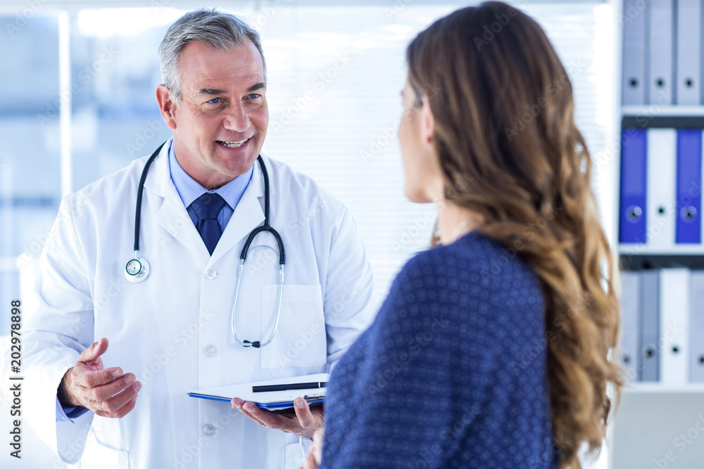 Male doctor with woman in clinic Male doctor with woman in clinic