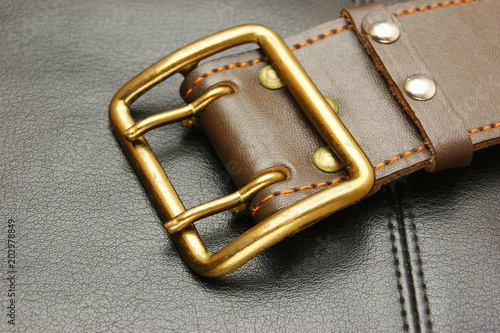 belt with a buckle on a black leather