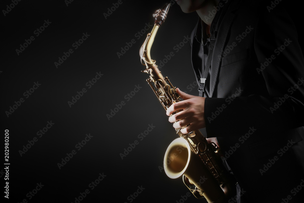 Naklejka premium Saxophone player. Saxophonist hands playing saxophone