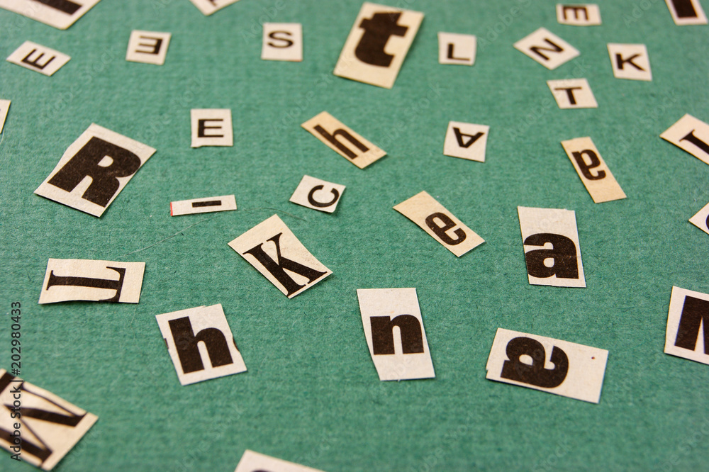 Collage word cut from newspaper on green background Collage word cut from newspaper on green background