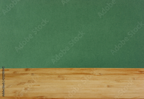 Old wooden deck table with green grunge background