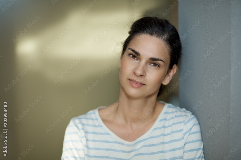 © nyul - Woman leaning against wall portrait