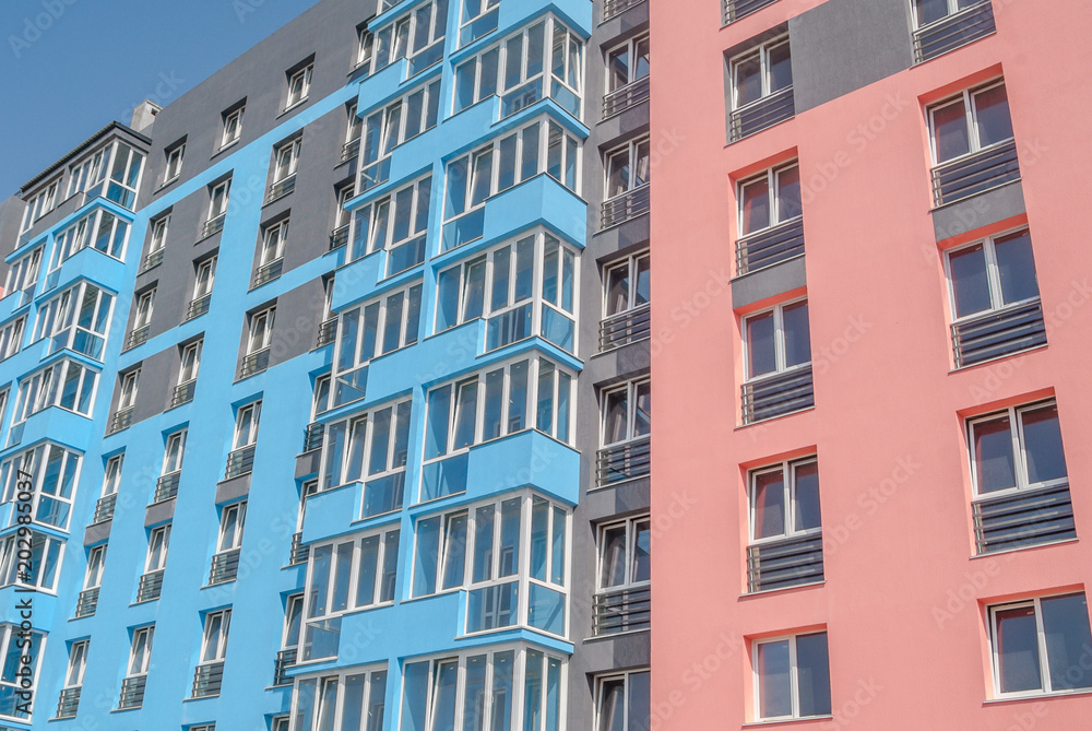 new multistory residential building, in the background, blue and pink texture