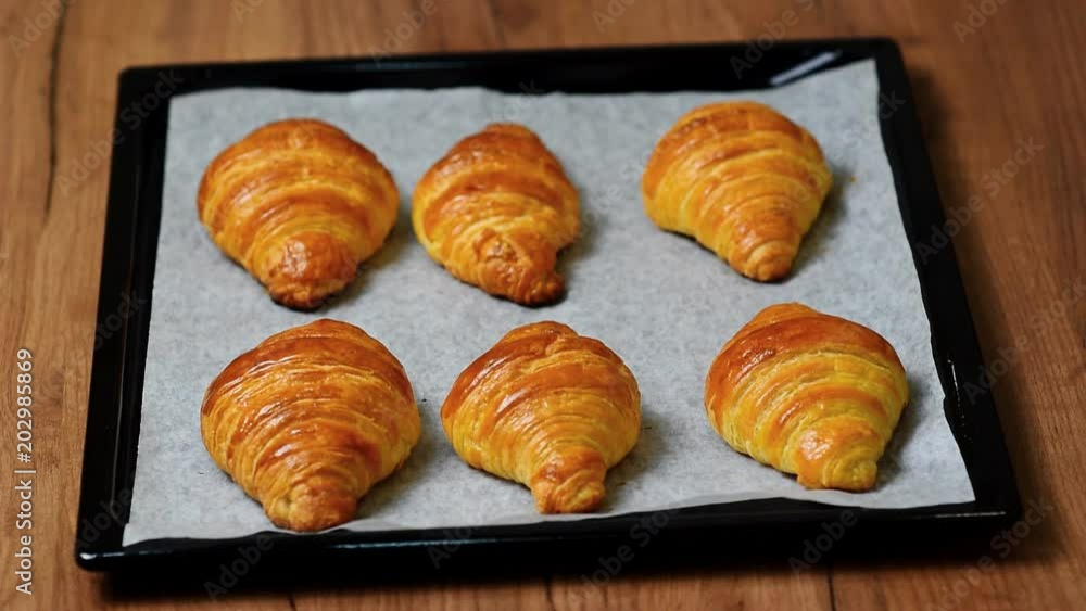 Fresh baked croissants on baking sheet Fresh baked croissants on baking sheet
